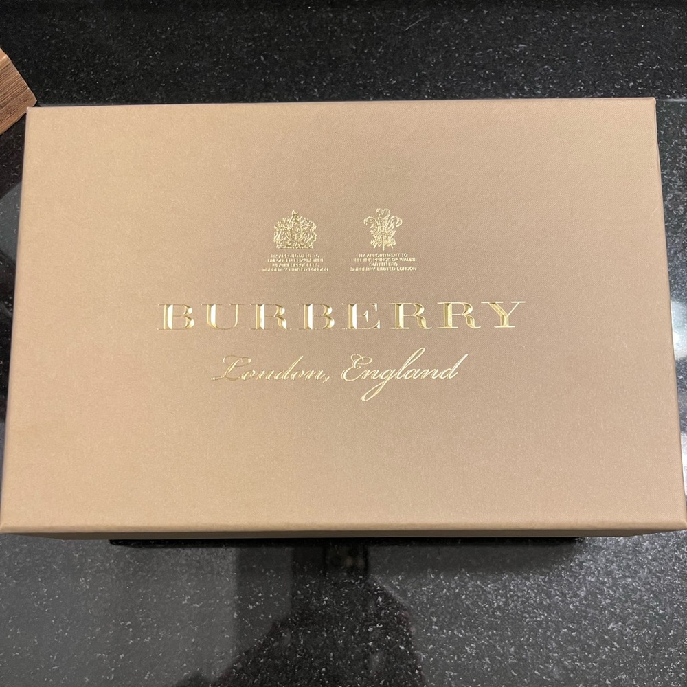 Burberry - Authentic and brand new! Smells like leather. Cream colored wallet